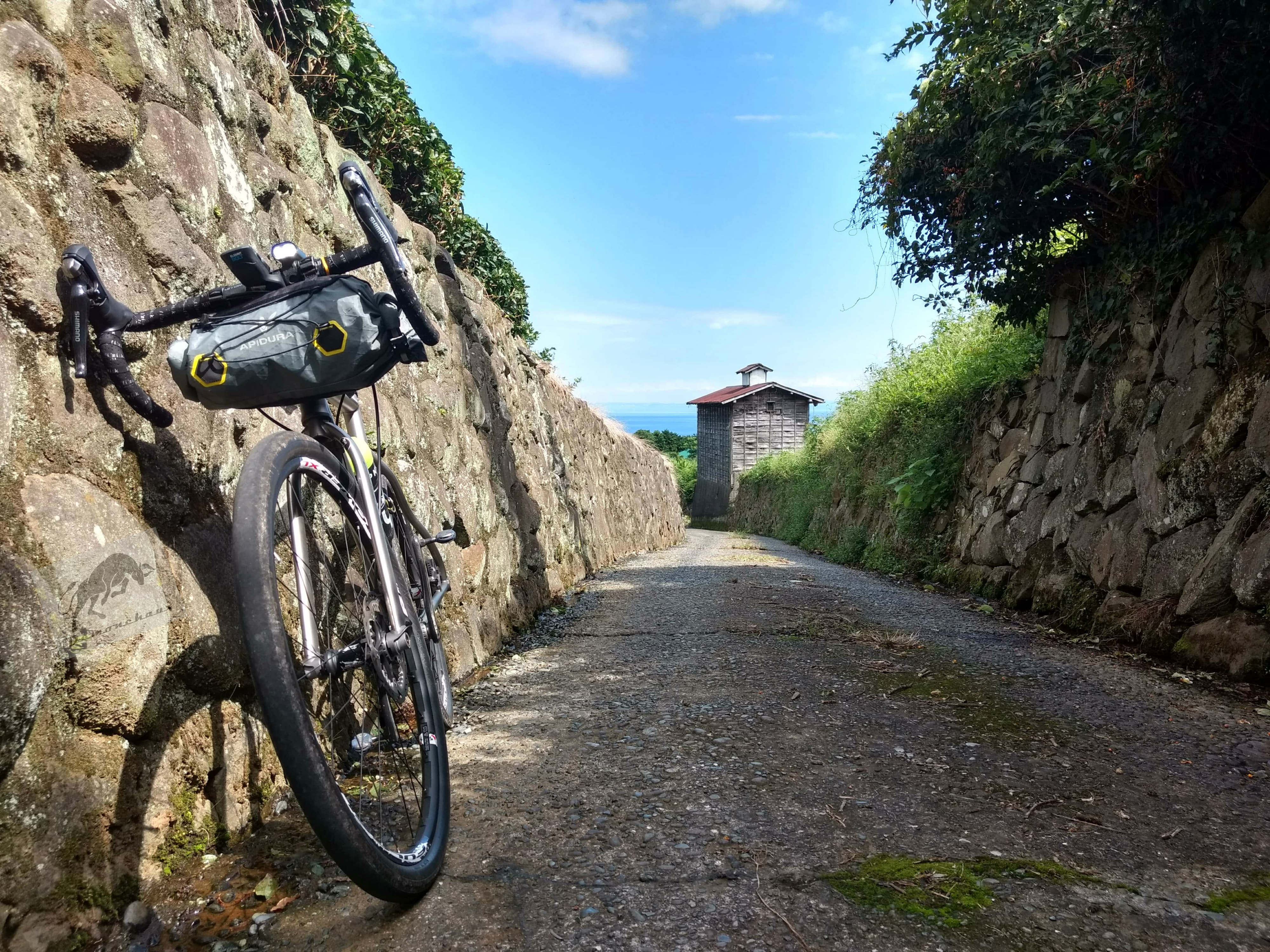 view of Spartacus bike in a small walled uphill road